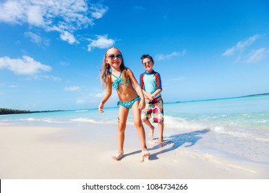 Brother and sister enjoying time at tropical beach