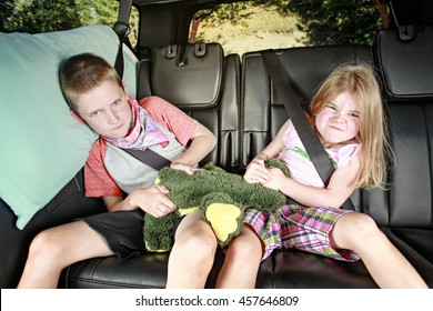 Brother And Sister Fighting In The Back Of A Car