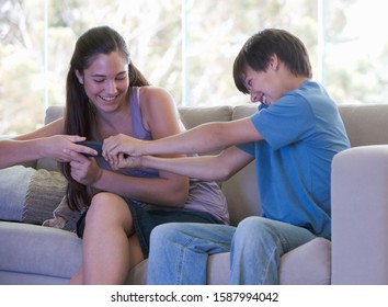 A Brother And Sister Fighting Over The Remote Control