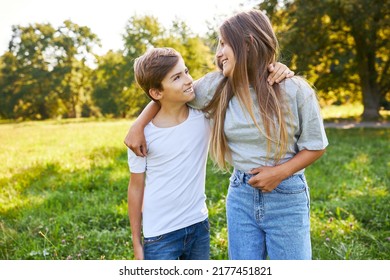 Brother And Sister As Happy Siblings Children Hug Each Other In Park In Summer