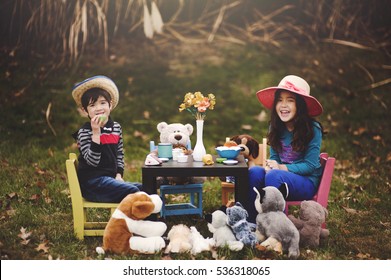 Brother and Sister having a Tea Party with Stuffed animals. - Powered by Shutterstock