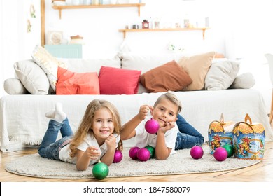 brother and sister holding new year gifts - Shutterstock ID 1847580079