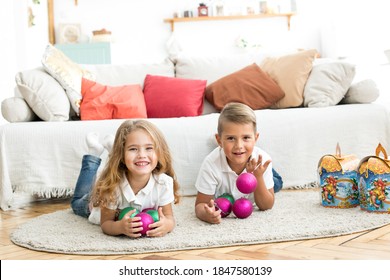brother and sister holding new year gifts - Shutterstock ID 1847580139