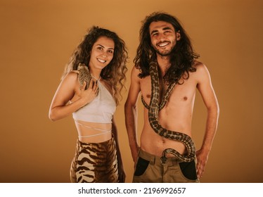 Brother And Sister Holding  Their Bearded Dragon And Dumeril's Boa At The Studio