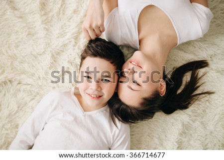 Brother And Sister Hugging And Smiling Lying On The Floor Brother And Sister Hugging And Smiling Lying On The Floor