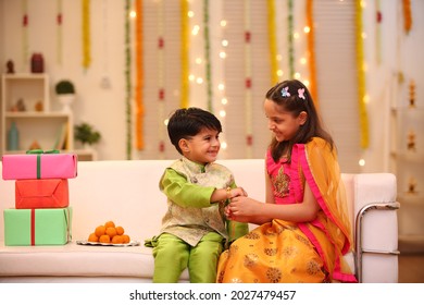 brother sister kids celebrating rakhi at home - Shutterstock ID 2027479457