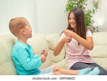 Brother And Sister Learn Sign Language At Home. Deaf Child