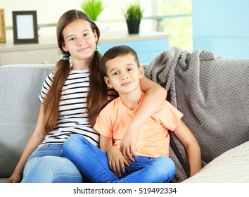 Brother And Sister On Couch