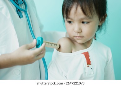 Brother and sister are playing doctor and hospital using stethoscope toy and medical uniform at home. Soft focus.