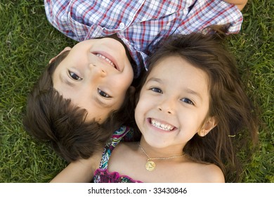 Brother And Sister Playing Outside