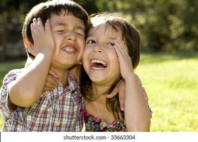 Brother And Sister Playing Outside