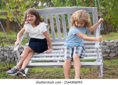 Brother And Sister Playing Outside. Little Boy And Girl Working In The Garden. Two Happy Children In Summer Park. Kids Summer Holiday Vacation Concept. Childrens Friendship.