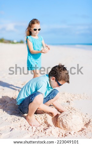 Similar – Two kids digging on the beach