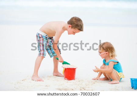 Similar – Two kids digging on the beach