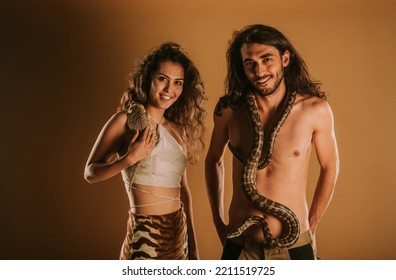 Brother And Sister Smiling With  Their Bearded Dragon And Dumeril's Boa At The Studio