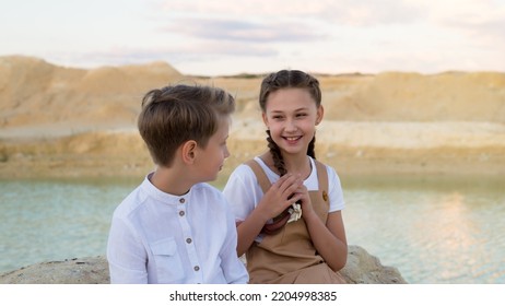 Brother And Sister Talking To Each Other Sharing Latest News.