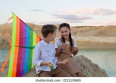 Brother And Sister Talking To Each Other, Sharing The Latest News.