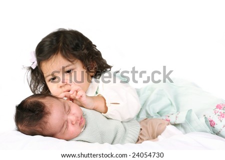 Similar – Image, Stock Photo Happy little girl holding doll and cookie while woman playing with a boy over the bed. Weekend family leisure time concept.