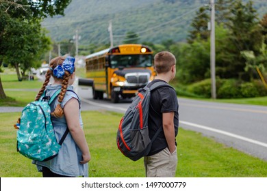 Brother And Sister Waiting For The Bus On The First Day Of School