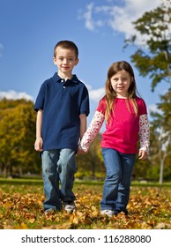 Brother And Sister Walking Holding Hands