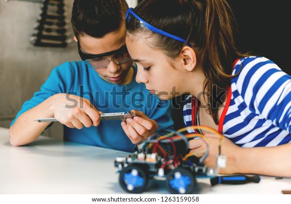 brother and
sister working on school project
together
