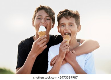 Brothers, boys and eating ice cream outdoor with portrait, hug and bonding in nature with dessert or snack. Teenager, cone and embrace in summer with confidence, hungry and enjoyment on weekend - Powered by Shutterstock