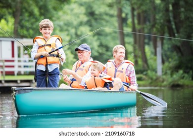 Brothers, Father And Grandfather Fishing In Lake