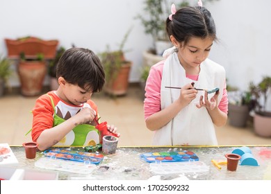 Brothers paint in the backyard of their home doing crafts and getting dirty. Candid images with natural light
