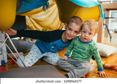 Brothers Playing In Their Built Indoor Fort In Living Room