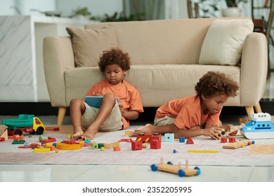 Brothers spending time at home playing with various toys - Powered by Shutterstock