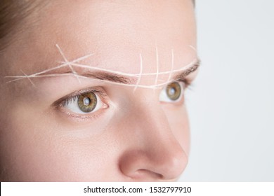 Brow Marking And Measuring Before Microblading Or Henna Tattoo Close-up. White Brow Paste, Threading.