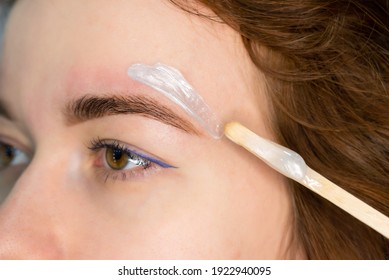 Brow Master Applying Hot Wax For Brows Epilation, Lamination And Waxing. Professional Care For Face And Brow Beauty Procedures. 