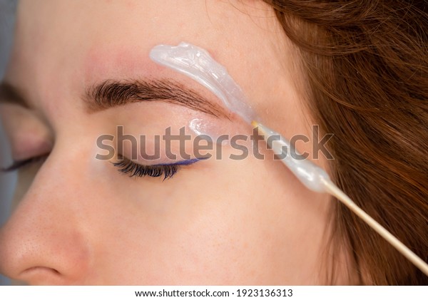 Brow master applying hot wax for brows epilation,\
lamination and waxing. Professional care for face and brow beauty\
procedures. 