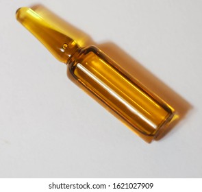 Brown Ampoule With Medicine On Light Background. Illness Treatment Concept. Pharmaceutical Business. Skincare Products