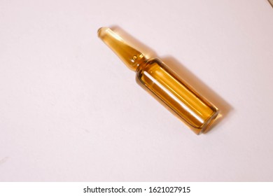 Brown Ampoule With Medicine On Light Background. Illness Treatment Concept. Pharmaceutical Business. Skincare Products