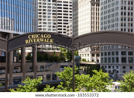 Brown arched sign to Chicago Riverwalk with tribune tower in background