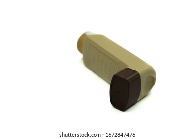 A Brown Asthma Inhaler Isolated On A White Background