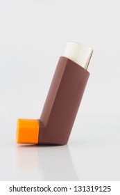 Brown Asthma Inhaler On White Background