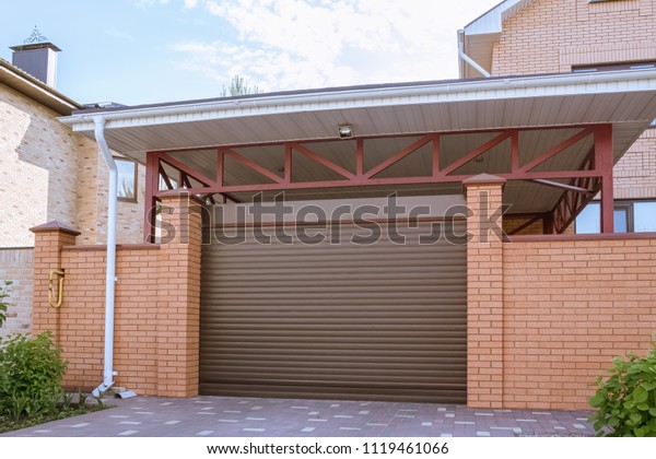 \
Brown automatic gates to\
the garage