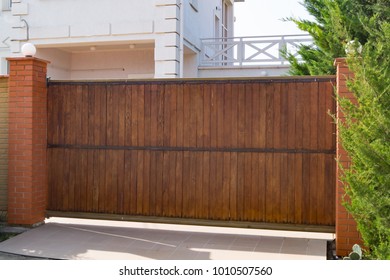 Brown automatic wooden gates of private house