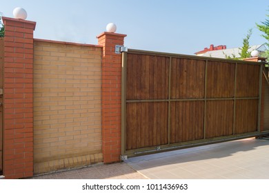 Brown automatic wooden gates of private house. Inside view