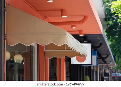 Brown Awning Over Shop Window. Canvas Roof Shading.