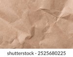 Brown background with a crumpled paper texture. The background features a natural, earthy brown color with a rustic, textured look. Light brown background. Craft paper texture background.