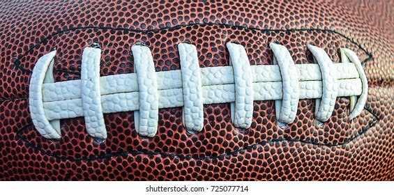 Brown Ball For Football With The White Laces. Close Up