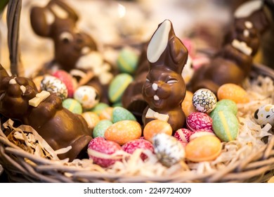 Brown basket with brown easter bunny chocolates and multi-colored easter eggs - Powered by Shutterstock