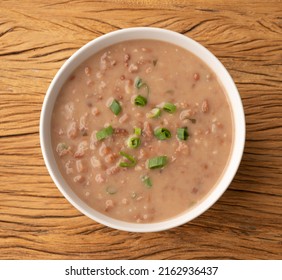 Brown Bean Soup In A Bowl Over Wooden Table.