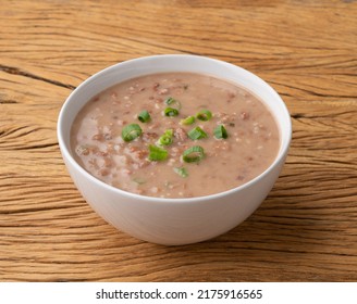 Brown Bean Soup In A Bowl Over Wooden Table.