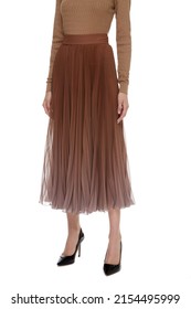 Brown Beige women's luxury evening Maxi Chiffon Pleated Skirt on model isolated on white background, woman wearing Long Glossy Skirt, autumn spring outfit, top front view. Long legs in hight heels