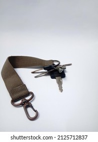 Brown Belt Strap Lanyard Rope, Hanging Metal Snap Hook Hook Carabiner For Motorcycle Key Ring, Isolated On White Background.
