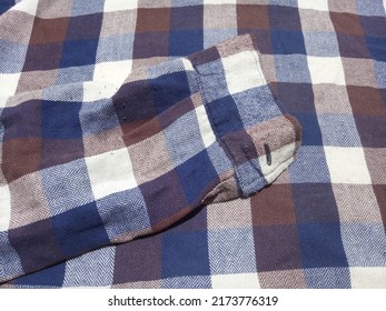 Brown, Blue And White Plaid Flannel Shirt Background With Sleeve